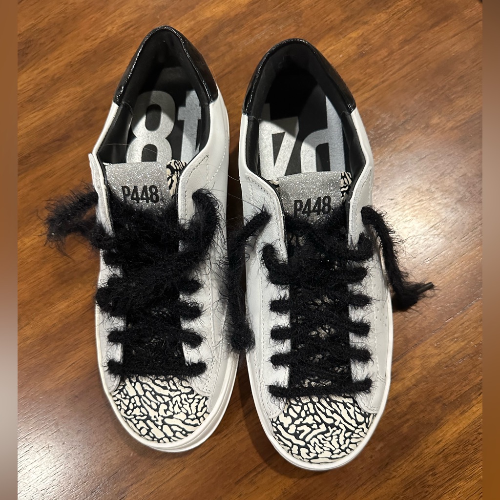 White P448 platform sneakers with black lettering, a resale fashion listing photographed from above